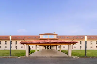 a large white building with a red roof at IBERIK Augas Santas Balneario & Golf in Pantón