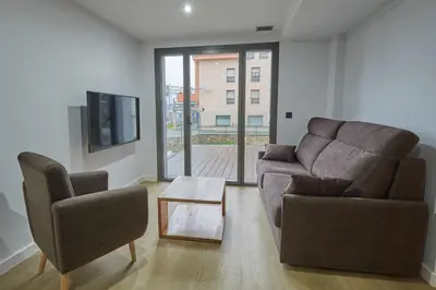 a living room with a couch and two chairs at HAVANAAPARTAMENTOS in Puerto de Vega