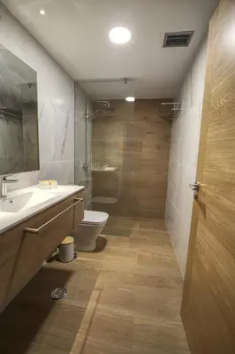 a bathroom with a sink and a toilet and a shower at HAVANAAPARTAMENTOS in Puerto de Vega