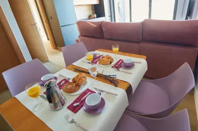 a table with plates of food and glasses of wine at HAVANAAPARTAMENTOS in Puerto de Vega