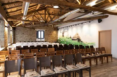 a large room with a table and chairs in it at Hotel Casa da Luz in Pastoriza