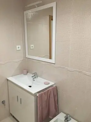 a bathroom with a sink and a mirror at Carmarez in Puerto de Vega