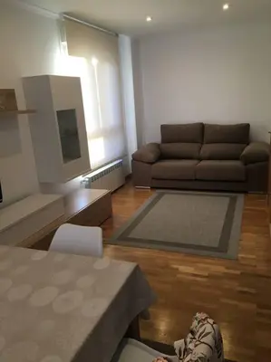 a living room with a couch and a table at Carmarez in Puerto de Vega