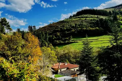 a house in the middle of a green hill at Hotel Cadario 1925 in Tebongo