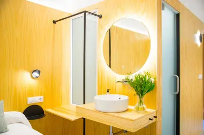 a bathroom with a sink and a mirror at KALIDAS HOSTEL SUITES in Caldas de Reis