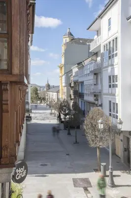 an empty street in a city with buildings at Hostal ALBA Lugo in Lugo