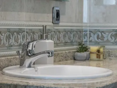 a bathroom sink with a faucet on a counter at Hostal ALBA Lugo in Lugo