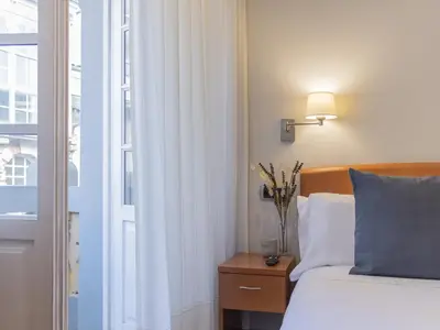 a hotel room with a bed and a window at Hostal ALBA Lugo in Lugo