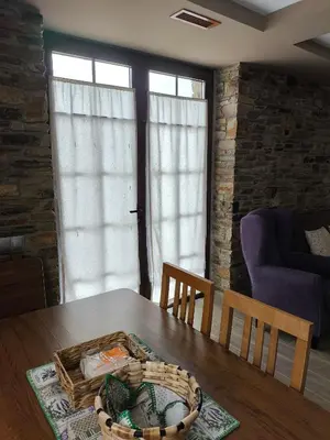 a bedroom with two beds and a large window at El Castro de Oscos in Murias