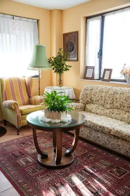 a living room with a couch and a table at Hotel Rústico Fonteverde in Cuntis