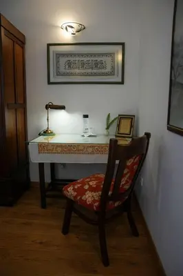 a room with a desk with a chair and a lamp at Hotel Rústico Fonteverde in Cuntis