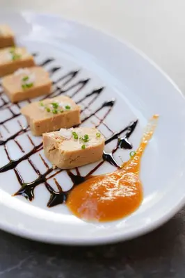 a white plate with some food on a table at Hotel Rústico Fonteverde in Cuntis