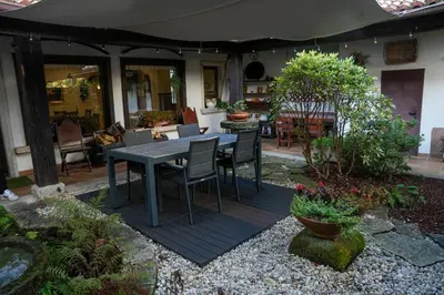 a patio with a table and chairs in a yard at Hotel Rústico Fonteverde in Cuntis