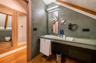 a bathroom with a sink and a mirror at Iberik Gran Balneario de Guitiriz in Guitiriz