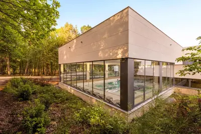 an image of a building with glass windows at Iberik Gran Balneario de Guitiriz in Guitiriz