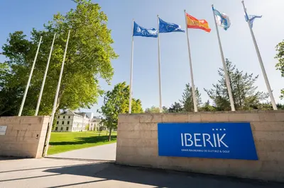 a sign with flags in front of a building at Iberik Gran Balneario de Guitiriz in Guitiriz