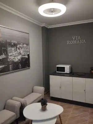 a hallway with a painting on the wall and a table at Pensión Atenea & Via Romana - Grupo Arcanos in Caldas de Reis