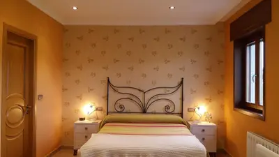 a bedroom with a bed and two night stands at Casa Aida in Foz