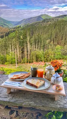 a table with plates of food on top of it at Sons do Eo- Apartamentos ecológicos en la montaña de Lugo in Baleira