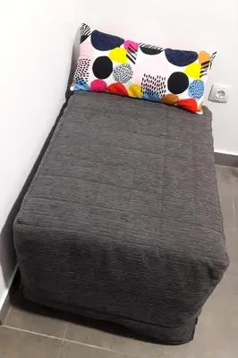 a bed in a room with two pillows on it at Sensacional Apartamento Saladina Home in Ourense