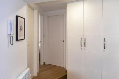 a white closet with white cabinets in a room at Sensacional Apartamento Saladina Home in Ourense