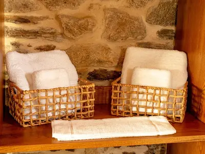 two wicker baskets sitting on a table with towels at A Casa da Fonte Azul in Ourense
