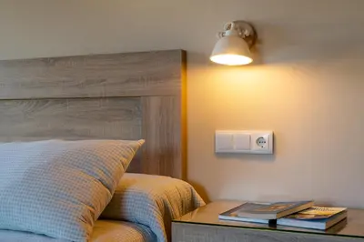 a bedroom with a bed and a table with books at A Casa da Fonte Azul in Ourense