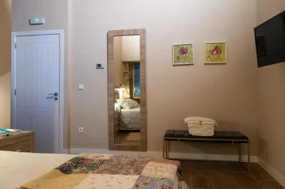 a bedroom with a mirror and a bed in a room at A Casa da Fonte Azul in Ourense