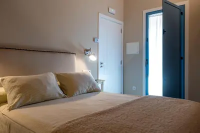 a bedroom with a bed and a door to a hallway at A Casa da Fonte Azul in Ourense