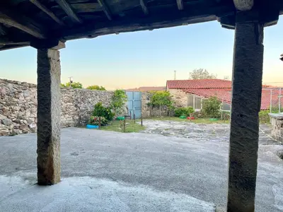 a view of a stone wall and a street at Casa Xulián in Monterroso