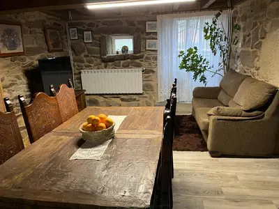 a wooden table with a bowl of fruit on it at Casa Xulián in Monterroso