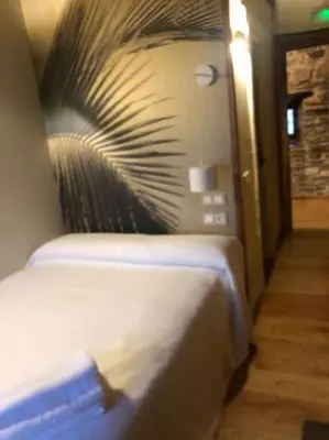 a bedroom with a bed with a plant on the wall at CASA DE ALDEA VAL DOS SOÑOS in Lugo