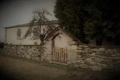 an old stone house with a fence and a stone wall at CASA DE ALDEA VAL DOS SOÑOS in Lugo
