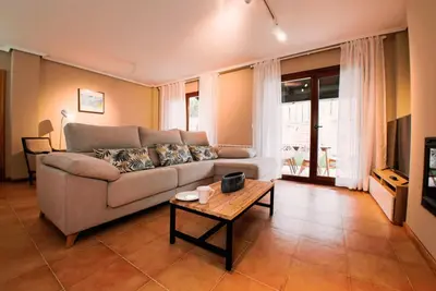 a living room with a couch and a table at Yuhom, casas con alma, Xacedos 1 in Miño