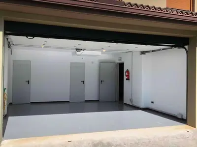 a large room with four white doors in a building at Yuhom, casas con alma, Xacedos 1 in Miño