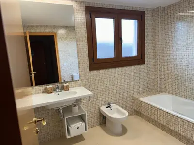 a bathroom with a sink and a toilet and a bath tub at Yuhom, casas con alma, Xacedos 1 in Miño