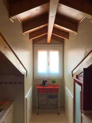a room with a red table and a window at Agarimo das Burgas in Ourense