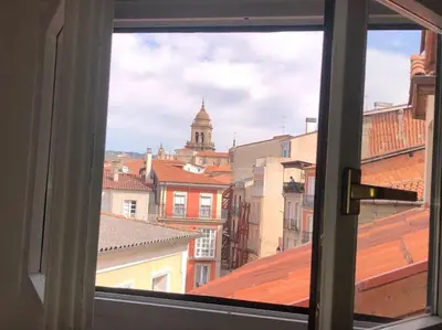 a view of a city from a window at Agarimo das Burgas in Ourense