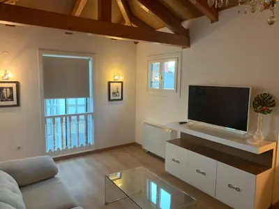 a living room with a couch and a tv at Agarimo das Burgas in Ourense