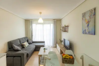 a living room with a couch and a table at Apartagal-Costa Reinante Spa in Barreiros