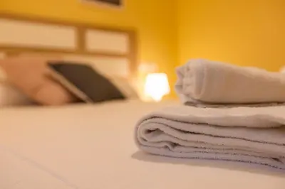 a pile of towels sitting on top of a bed at Apartagal-Costa Reinante Spa in Barreiros