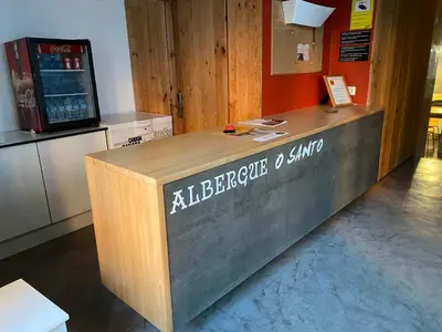 a bar in a restaurant with a beverage stand at Albergue O Santo in Arzúa