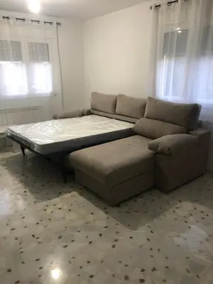 a living room with a bed and a couch at Casa turismo rural Becar in Corullón