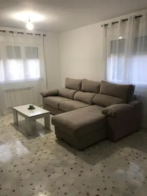 a living room with a couch and a table at Casa turismo rural Becar in Corullón