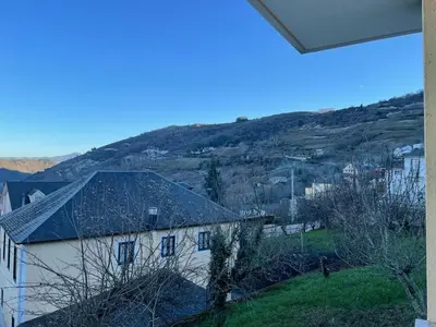 a view of a house with a hill in the background at Casa turismo rural Becar in Corullón