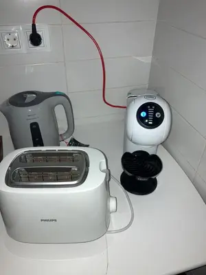 a white toaster sitting on top of a counter at FOZ II PLAYAS in Foz