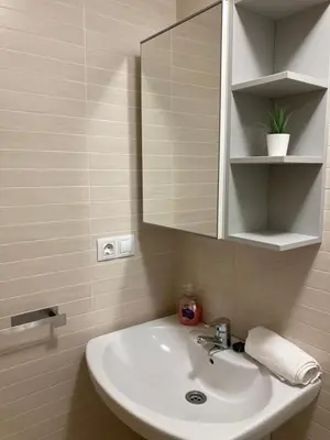 a bathroom with a white sink and a mirror at FOZ II PLAYAS in Foz