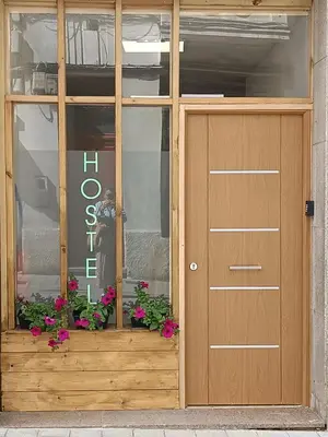 a door to a store with flowers in front of it at Hostel Bretema in Lugo