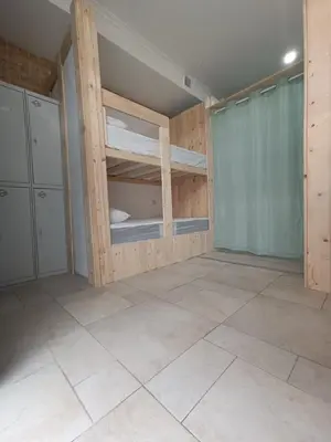 a room with bunk beds and a tiled floor at Hostel Bretema in Lugo