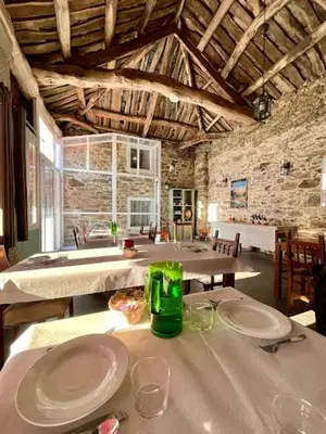 a room with a table with plates and glasses on it at Albergue Ponte Ferreira CAMINO PRIMITIVO Lugo - Ferreira in Lugo